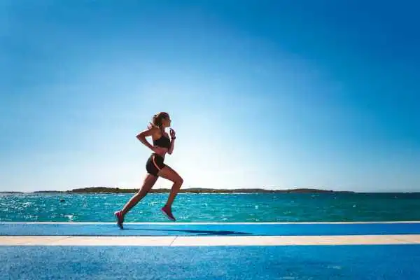 Woman running showing strong leg muscle Salisbury